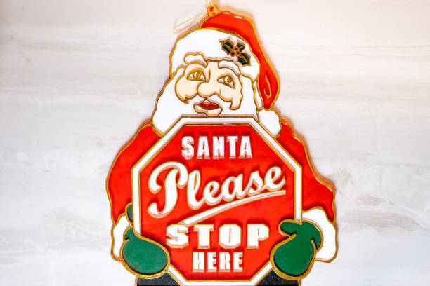 Santa Ornament with "Santa Please Stop Here" on White Background stock photo