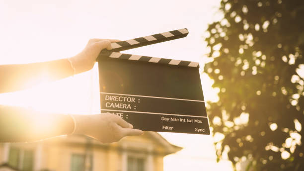 film slate on women's hands in the sunset.Storytelling and New Age Filming industry concept. film slate on women's hands in the sunset.Storytelling and New Age Filming industry concept. image type stock pictures, royalty-free photos & images