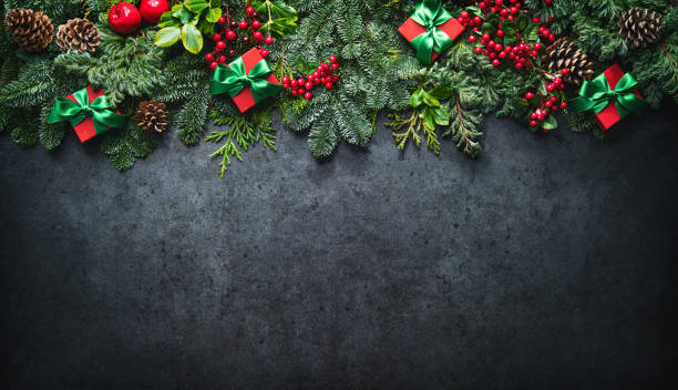 istock Christmas background with pine branches, berries, decorations and gift boxes 1357706385