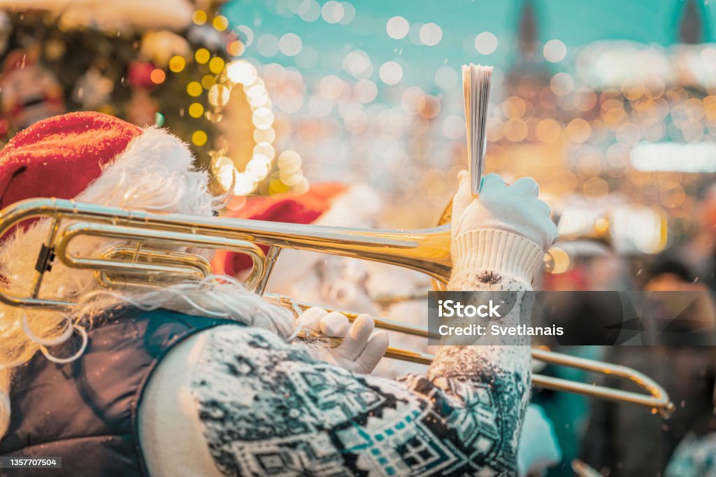 Performance of Santa Claus musician. Christmas and New Year city party. Performance of Santa Claus musician holding sheet music. Christmas and New Year city party Christmas Stock Photo