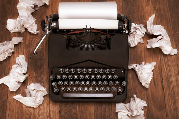 istock Retro vintage typewriter with crumpled paper on wooden table 1357708455