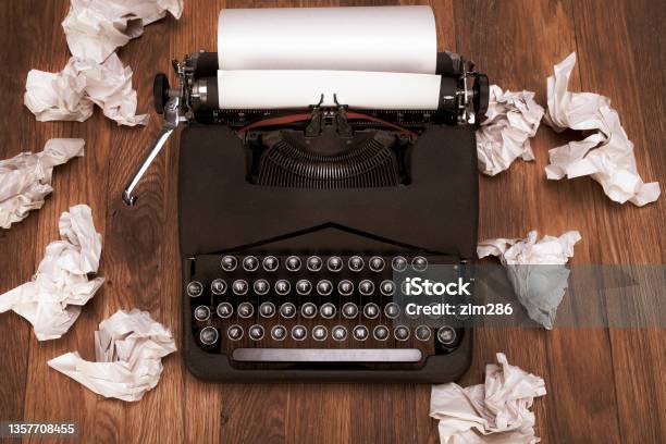 Retro Vintage Typewriter With Crumpled Paper On Wooden Table Stock Photo - Download Image Now