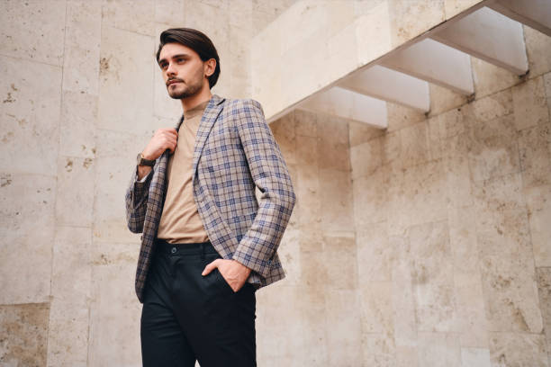 istock Young attractive stylish man in checkered jacket thoughtfully looking away outdoor 1357709716