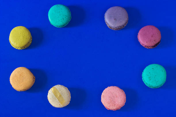 istock Funny colorful macaroon cookie dessert with blue background 1357710911