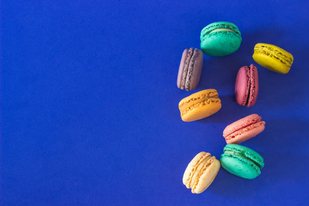 istock Funny colorful macaroon cookie dessert with blue background 1357710998