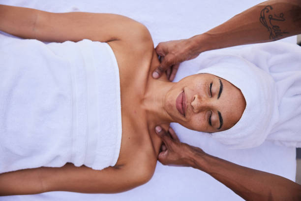 istock Smiling woman getting a shoulder massage while lying on a table spa table 1357713119