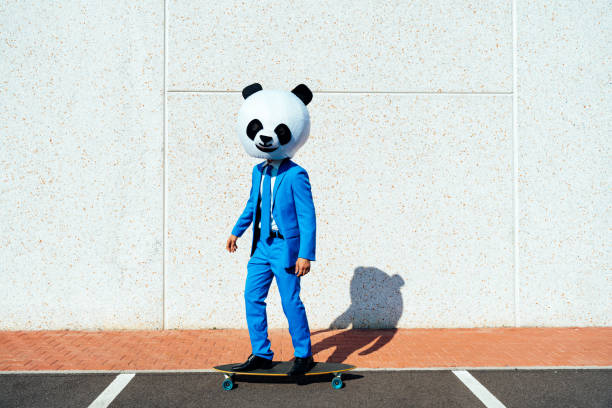 Storytelling image of a man wearing giant panda head and colored suits