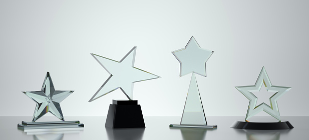 Glass award stars on gray background. 3D rendering