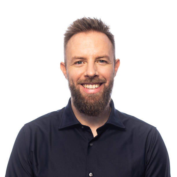 istock Studio portrait on white background of young man with beard smiling 1357723127