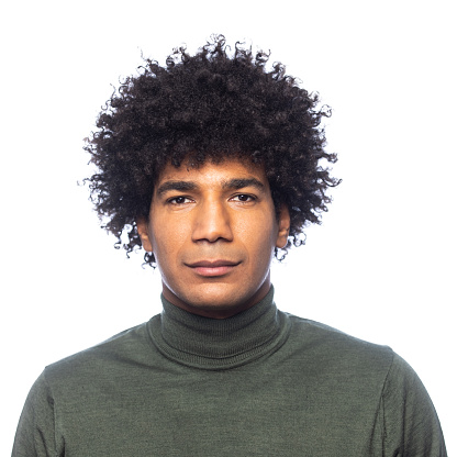 Man with an afro looking serious into the camera during a photo session in a photo studio