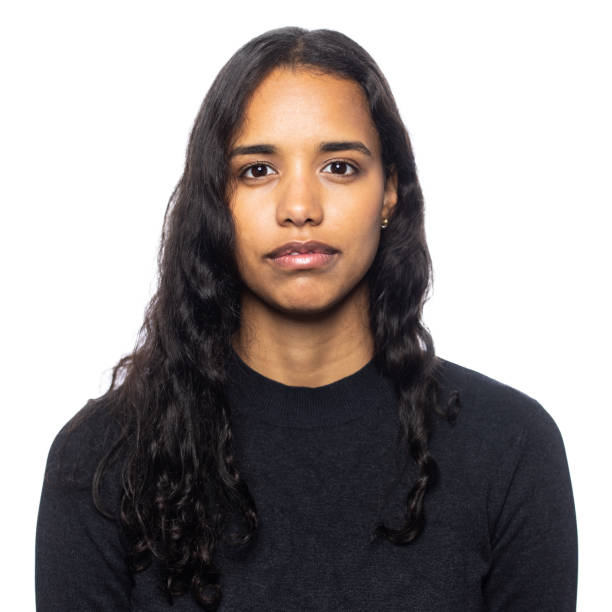istock Young latin woman looking serious in a studio portrait on white background 1357723734