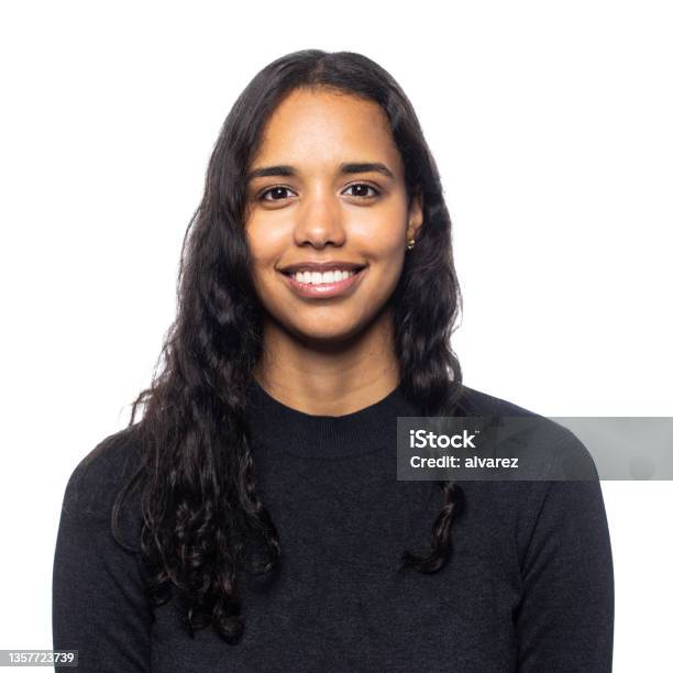 Studio Portrait Of A Smiling Young Latin Woman Stock Photo - Download Image Now - Portrait, White Background, Latin American and Hispanic Ethnicity