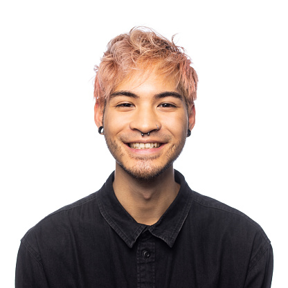 Very friendly young man with pink hair smiling at the camera