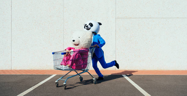 Storytelling image of a couple wearing giant panda head Storytelling image of a couple wearing giant panda head and colored suits. Man and woman making party in a parking lot. bizarre stock pictures, royalty-free photos & images