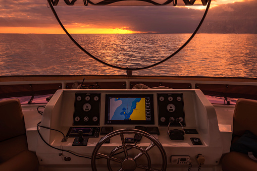 Cockpit of the yacht at sunset in the Atlantic Ocean sea on a cloudy day.