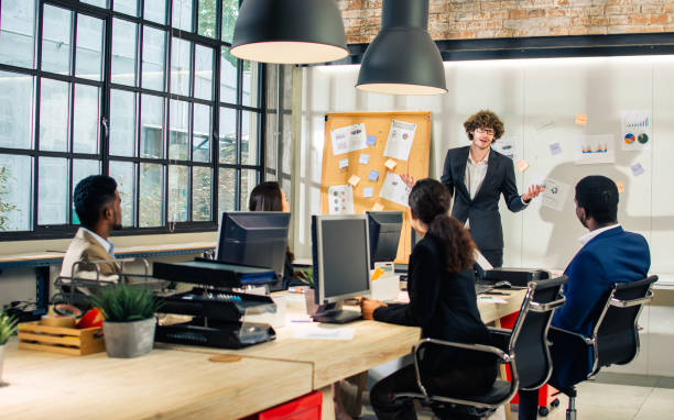 istock Selective focus young handsome smart Caucasian Businessman or boss wearing suit, smiling with happiness, confidence, presenting marketing plan or creative idea in meeting room at indoor modern office. 1357726160