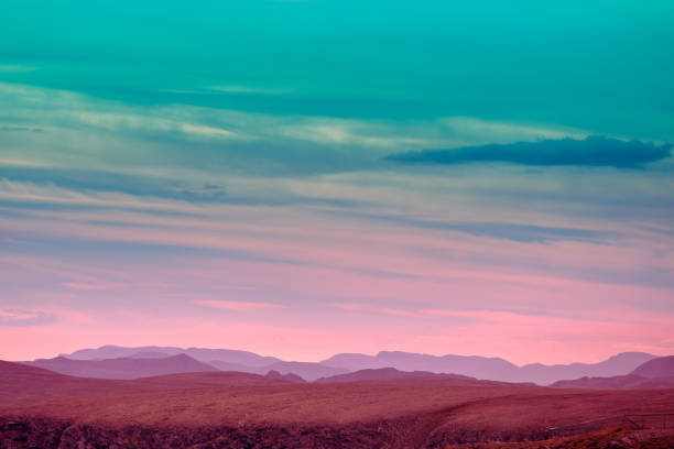 Silhouette of mountain ridge against sunset sky. stock photo