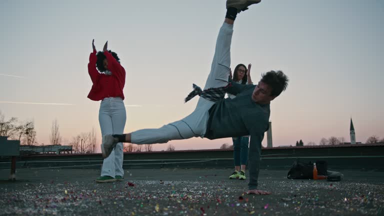 Young dancer doing breakdance moves on rooftop