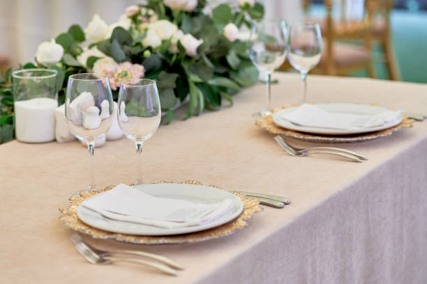 istock Table setting with sparkling wineglasses, plate with white napkin and cutlery on table, copy space. Place set at wedding reception. Table served for wedding banquet in restaurant 1357727876