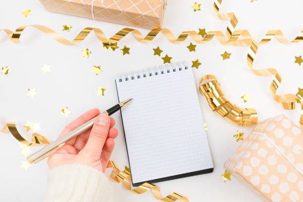 istock Festive decorations and notebook with wish list on white background , flat lay . Planning concept. 1357729041