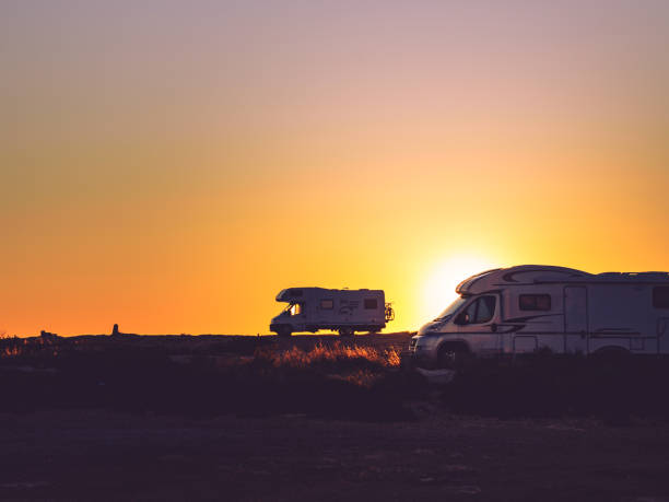 istock Camper cars on beach at sunset 1357729850