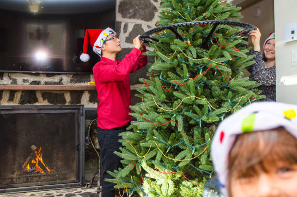 istock Mixed race couple decorating Christmas tree 1357732740