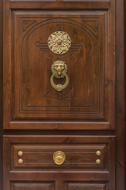 istock antique wooden brown door with monograms 1357733343