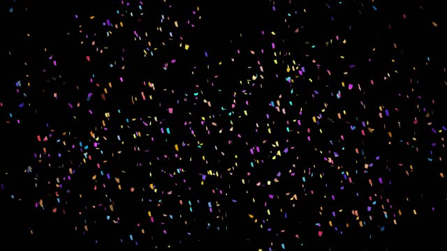 Multicolored confetti exploding on a black background with copy space