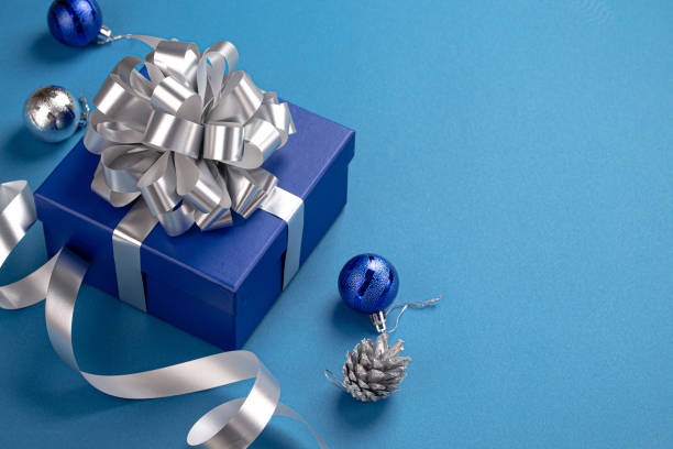 istock Christmas composition with present and decorations in blue and silver colors 1357740066