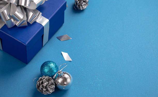 istock Christmas composition with present and decorations in blue and silver colors 1357740072