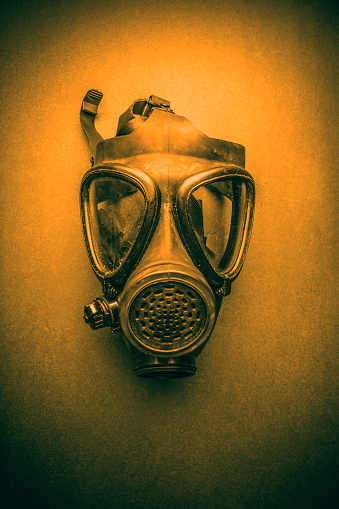 A creepy gas mask with an orange glow.