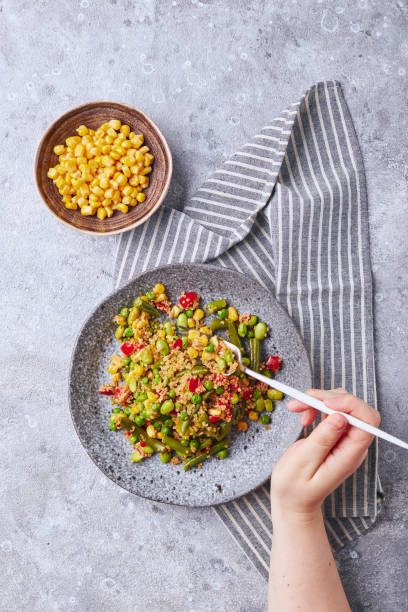 istock Quinoa salad with green beans, corn, red bell peppers, peas and soybeans. Useful vegetable mix 1357741396