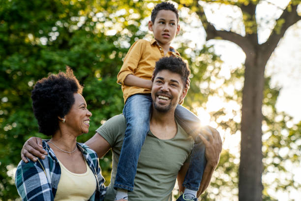 istock Young loving family having fun in the park 1357742399