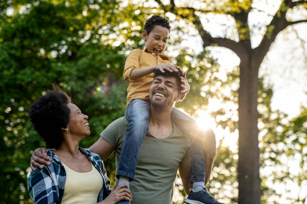 istock Young loving family having fun in the park 1357742404