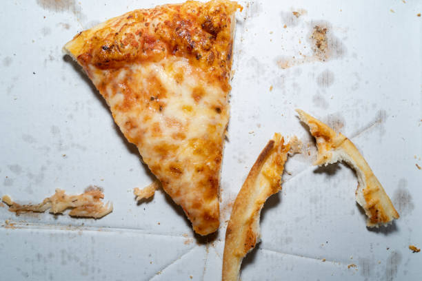 istock A piece of leftover margherita pizza and two crusts on a pizza box 1357742736