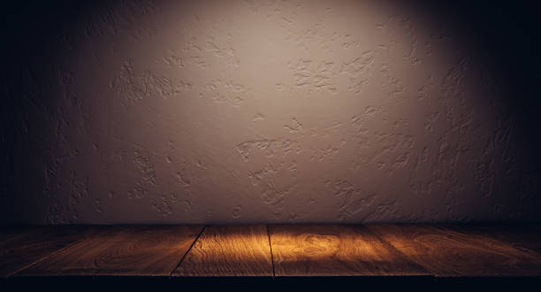 istock Oak plank podium or table in the dark with stone wall 1357743153