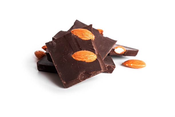 istock Dark chocolate with cocoa and whole almond isolated on a white background 1357748665
