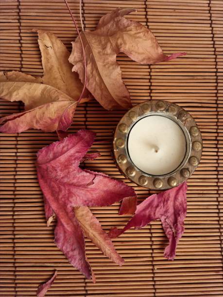istock Autumn leaves with candle 1357750200