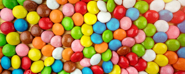 istock Background of multicolored sweet candy assorted on table surface 1357750299
