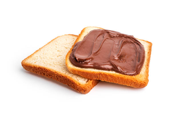 istock Toast with cocoa paste isolated on a white background. A piece of bread with chocolate paste 1357750494