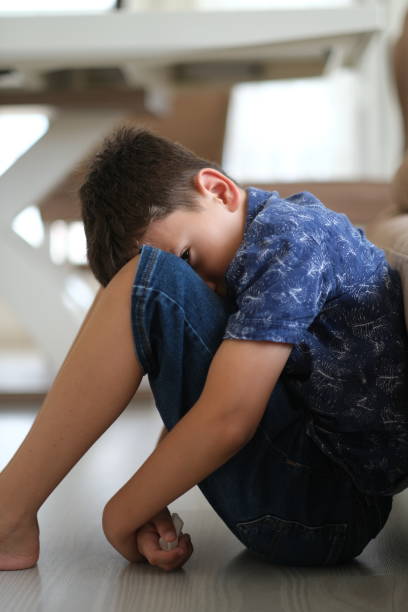 istock Sad child at home 1357751244