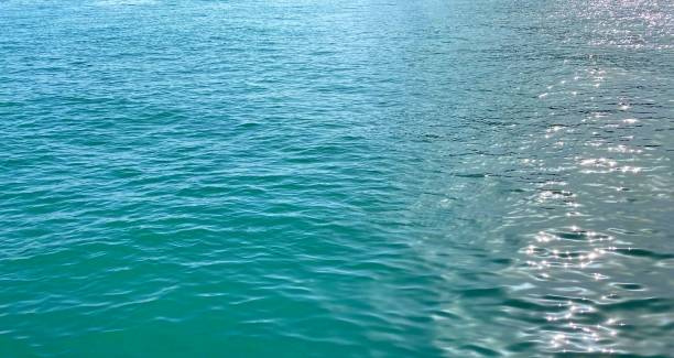 istock Beautiful blue sea shiny background.  Turquoise ocean waves. 1357751493
