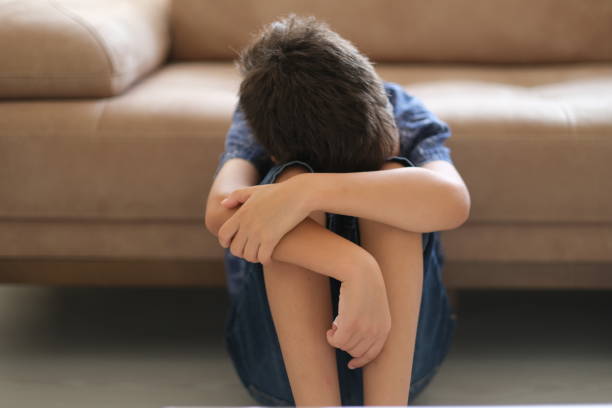 istock Sad child at home 1357751648