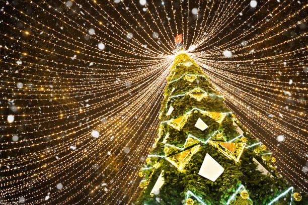 High city Christmas tree in the park with a cap of lights garlands, glows at night on the street. Christmas, new year, decoration of the city. Kaluga, Russia stock photo