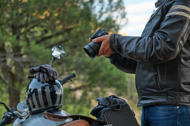 istock Man with a camera in his hand next to his bike. 1357751941