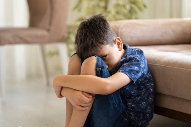 istock Sad child at home 1357753073