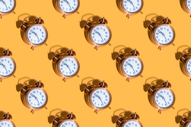 istock Alarm clock on a colored background hard shadows. Close up. Seamless patterns 1357754293