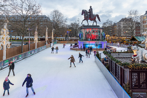 Cologne, Germany - Dec 2nd 2021: Outdoor ice surface attracts people skating in Cologne Christmas market.