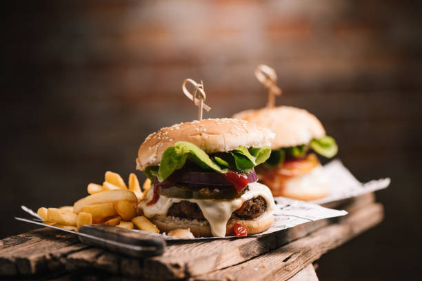 istock Tasty hamburger on wood background 1357756753