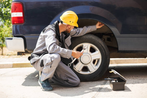 istock Young mechanic in work clothes and yellow hardhat using wrench f 1357758050
